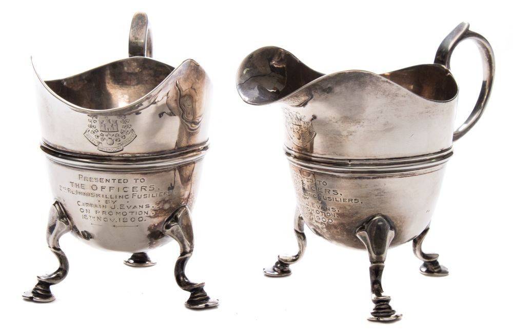 Two late Victorian silver presentation cream jugs for the 2nd Royal Inniskilling Fusilers,