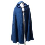 A blue wool dress cape with hood:, lined in blue silk with black frogging.