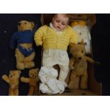 Four various blonde plush Teddy bears together with a composition headed baby doll and a white