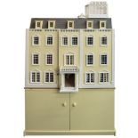 A large modern dolls house in the style of a Georgian mansion: with pillared portico,