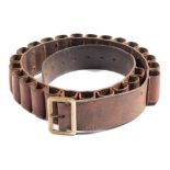 A brown leather 12 bore cartridge belt with brass buckle:.