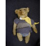 An early 20th century Stieff blonde plush Teddy bear:, with button to left ear,