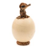 A preserved baby Emu head set in an emu egg under a glass dome:, (no base to dome) 26cm high.