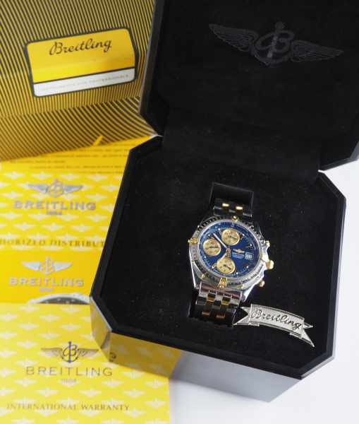 7.5.) Uhren Breitling - Chronomat Automatic.Stahl und Gold, marineblaues Zifferblatt mit goldenen