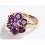 9 carat gold ring, set with purple stones to form a flower head, ring size Q