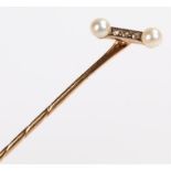 Diamond and pearl stick pin, with a pair of pearls to each end of the diamond set head, 7cm high