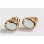 Pair of 9 carat gold opal set earrings, with oval opals set within mounts