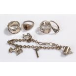Silver jewellery, to include four silver rings and a silver charm bracelet, (5)