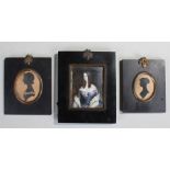 British school, a lady wearing a blue dress, oil on board, together with two silhouettes, (3)