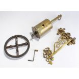 19th Century brass bottle jack and key, with ornate brass bracket and wheel. The bottle jack made by