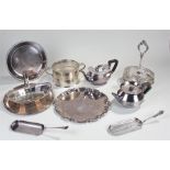 Silver plated wares. to include three plates, two crumb scoops, a basket, dish ring, cruet stand and