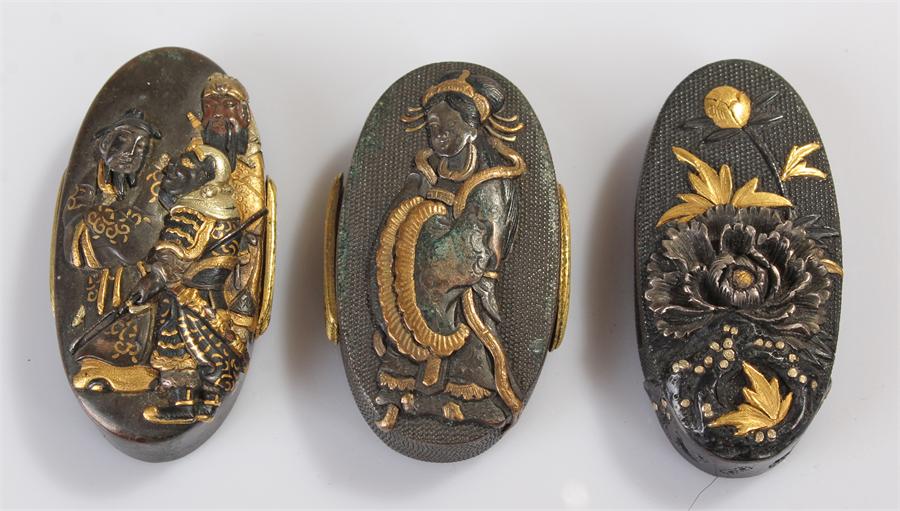 Three Japanese Kashira with shakudo decoration, decorated with a female figure with gold