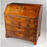 George I walnut bureau, the rectangular top above a cross banded sloping fall enclosing a series