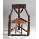 Victorian oak turners chair, the carved rail back with reeded arms and solid seat on turned legs