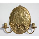 18th Century brass wall sconce, with a flower to the centre surrounded with scrolls and half