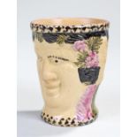 19th Century Staffordshire pottery cup, with a male and female character face to either side painted