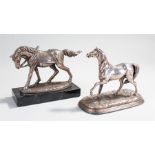 Two silver plated models of horses, one with a saddle attached and the letter N to the edge, 18cm