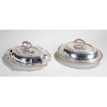 Two silver plated entrée dishes, the first with acanthus leaf arch handle above a lid with monogram,