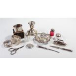Collection of silver, to include silver capped bottles, napkin ring, a dish, candlestick, vanity