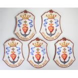 Set of five painted shields, each within a red border and anchor with the initials JMJ the Latin