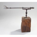 18th Century toasting fork, the rod with a spiked end to the baluster column on a block, 36cm long