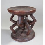Nigerian Ibo prestige stool, the dish top above with eight angled arms on a line carved base, 30cm