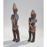 Two African carved figures, of warriors holding shields, the tallest 36cm high. From the