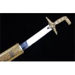 Saudi Arabian presentation sword, the gilt metal sword with inset red beads, steel blade, 94cm long