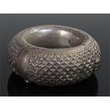 Zanzibar white metal bangle, of thick proportions, decorated with a geometric pattern, 10.5cm wide