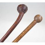 Two African knobkerrie clubs, both with ball ends and tapering handles, (2)