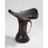 African stool, with an arched top with cut in semi circles above the shaped column and dome base,