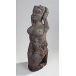 African carved figure, in kneeling position with arms behind the head, 48cm high