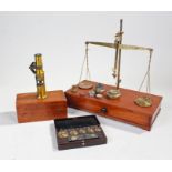 Cased microscope, with slides together with a weight set and a mahogany set of scales, (3)