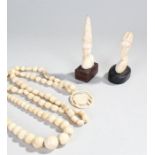 Early 20th Century African ivory, to include two busts, two bead necklaces and a bone necklace, (5)