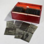 Cased collection of magic lantern photographic slides, with figures, still life images and scenes