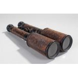 Pair of early 20th Century binoculars, of long proportions, leather grips, 30cm long