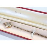 Talis 9 carat gold ladies wristwatch, the signed silvered dial with 9 carat gold strap