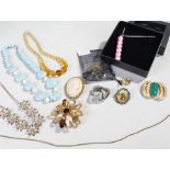 Mixed lot of costume jewellery comprising of four necklaces, four brooches, one belt buckle, one