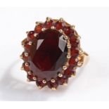 9 carat gold garnet set ring, with an oval garnet above further garnets