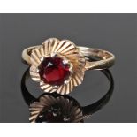 9 carat gold garnet ring, the central garnet set to a flower head design, ring size M 1/2