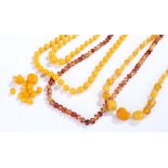 Amber and Bakelite jewellery, to include three necklaces and loose beads