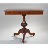 Victorian walnut games table, the hinged rectangular top above a turned and carved column and