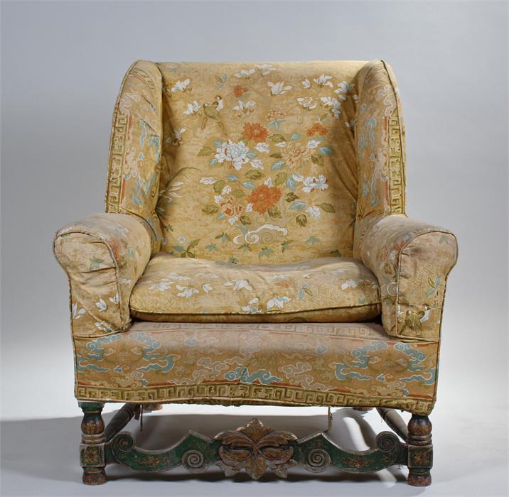 George I style wing back armchair, the stuff over upholstered back, seat and arms above green