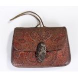 19th Century Japanese leather and fuchi kashira tobacco pouch, the swag decorated pouch with a mixed