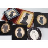 Five silhouettes , three in black papier mache frames and two in black frames to include a pencil