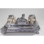 Egyptian revival silver plated desk stand, centred by a sphinx reclining above a lidded container