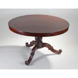 Victorian rosewood breakfast table, the circular top above a turned column and scroll cabriole legs,