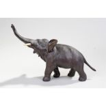 Meiji period Japanese bronze and ivory elephant, with trunk raised into the air and walking