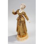 Attributed to Georges Omerth (French fl.1895-1925) An ivory and gilt bronze figure of lady, carved