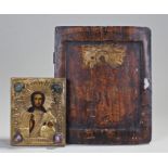 Two icons, the first on board painted with a Saint, 32cm high, the second on board painted and